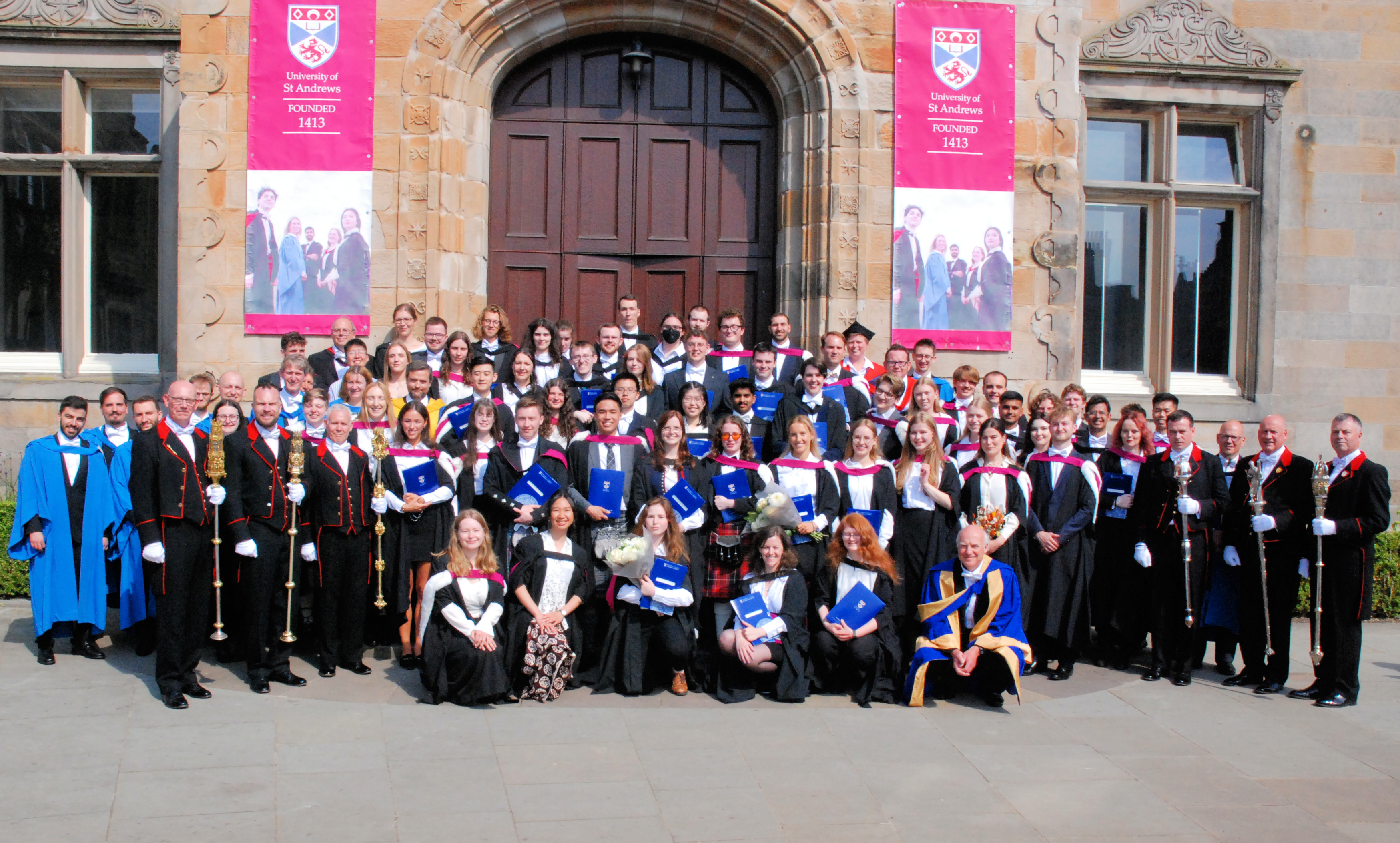 Dr Maria Papa in her graduation gown and Janet smiling at Graduation.
